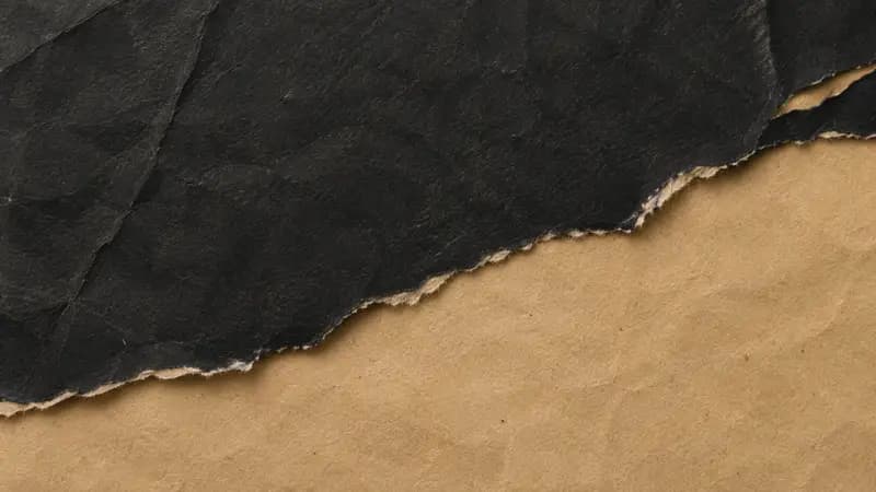 Torn paper texture in charcoal dark sand